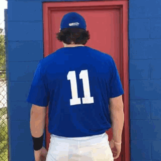 a baseball player wearing a blue jersey with the number 11 on it