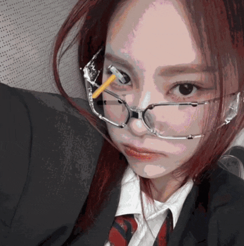 a woman wearing glasses has a cigarette in her nose