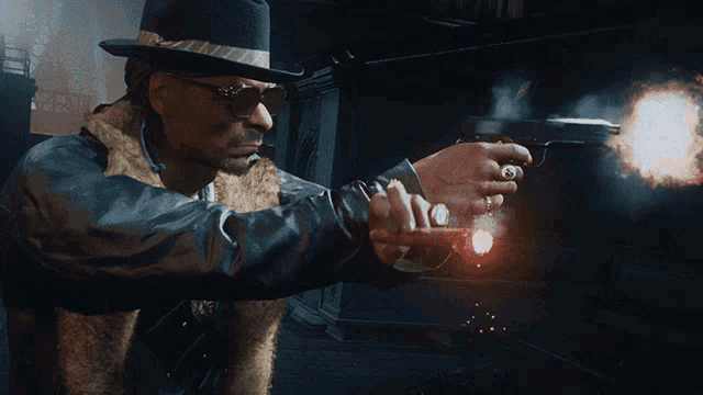 a man in a hat and fur coat is holding a gun in his right hand