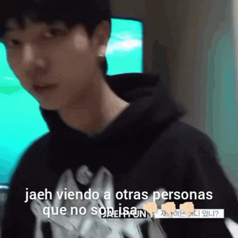 a man in a black hoodie is talking to someone in another language