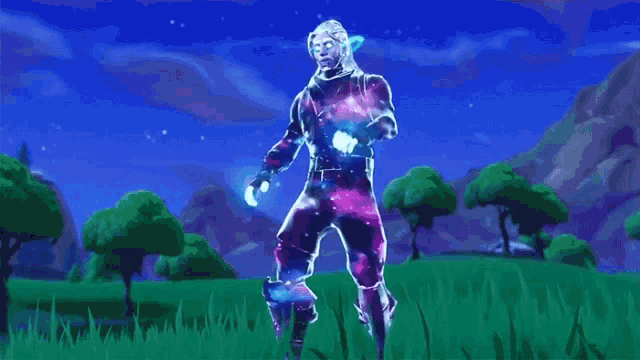 a person in a galaxy suit is standing in a field of grass .