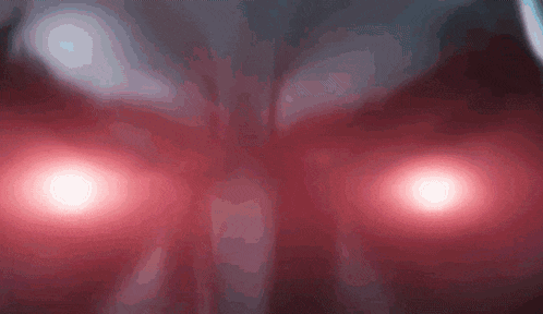 a close up of a person 's face with red eyes