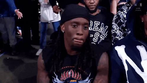 a man with dreadlocks wearing a shirt that says ren