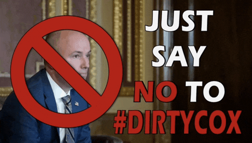 a man in a suit and tie is sitting in front of a sign that says just say no to #dirtycox