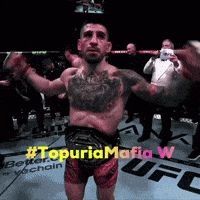 a man in a boxing ring with #topuriamafia w written on the bottom right