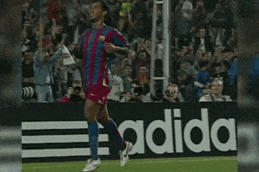 a soccer player wearing a number 10 jersey is running on the field