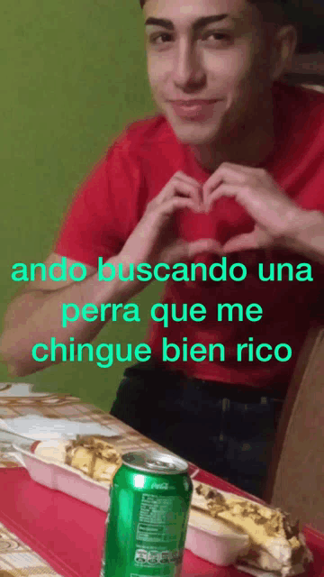 a man making a heart shape with his hands next to a can of sprite