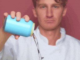 a man in a white coat is holding a blue can in his hand
