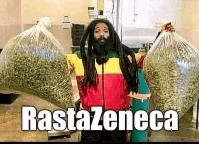a man with dreadlocks is holding bags of marijuana .