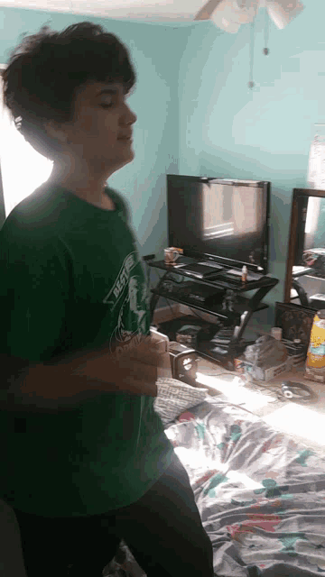 a boy wearing a green shirt that says rest on it is running