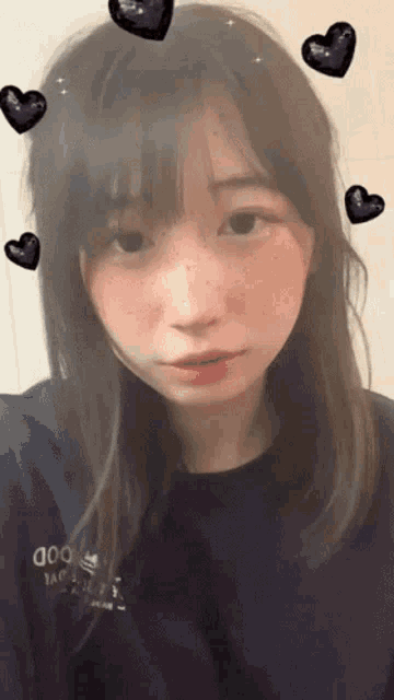 a girl wearing a blue shirt that says ' good ' on it