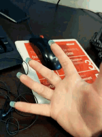 a person 's hand is on a mouse pad that says cc
