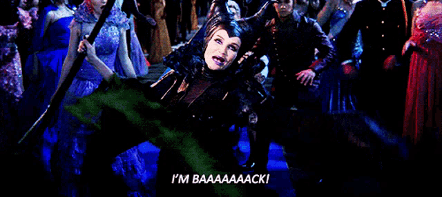a woman in a maleficent costume says i 'm baaaaaaack
