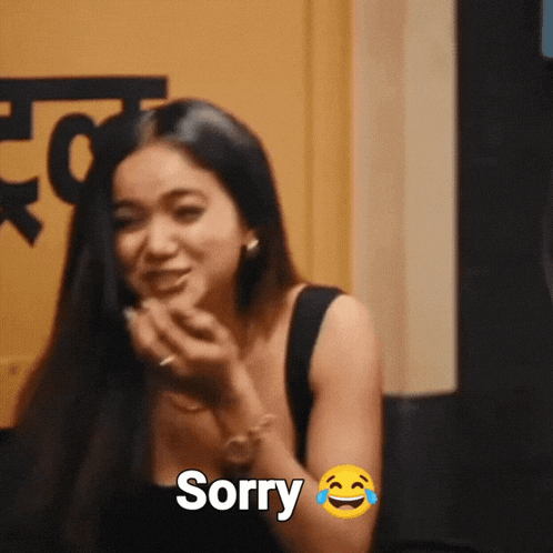 a woman is making a funny face with the word sorry next to her