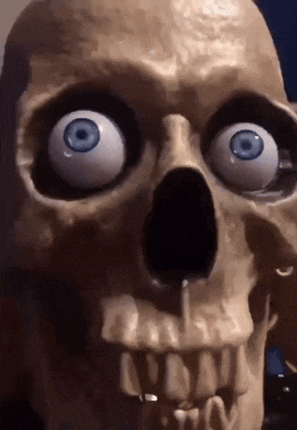 a close up of a skull with blue eyes and teeth