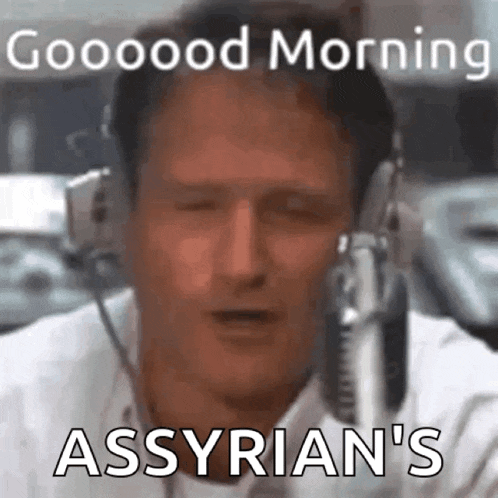a man is wearing headphones and talking into a microphone .
