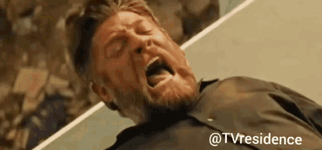a man with a beard is laying down with his mouth open and the words @tvresidence below him