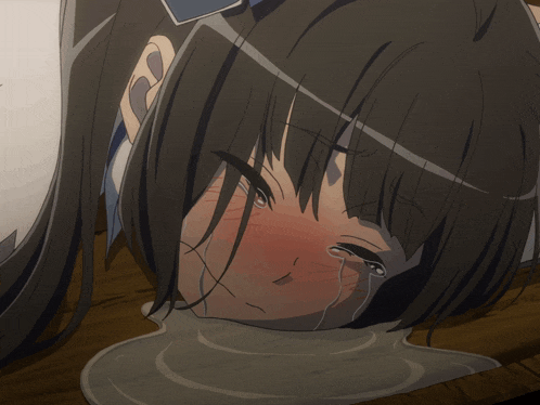 a girl with tears running down her face laying on a table