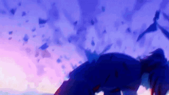 a person is laying on the ground in front of a purple sky with birds flying in the background .