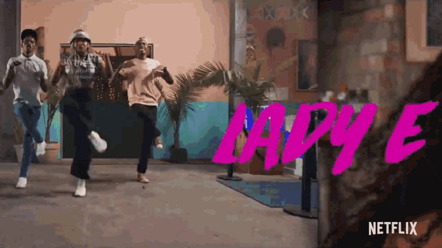a group of people are dancing in front of a sign that says " netflix "
