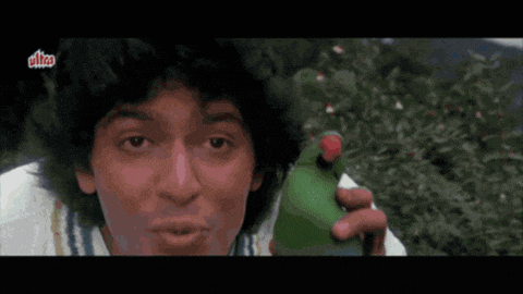 a man is holding a green bottle with a red cap and the word ultra on it