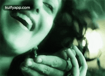 a woman is holding a man 's hand and laughing .