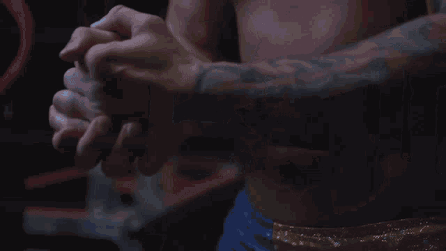 a shirtless man with a tattoo on his chest