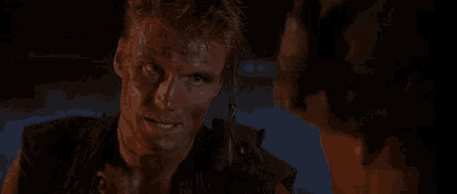a man with blood on his face is talking to another man with the words " do you hear me " behind him