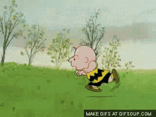 a cartoon of charlie brown running in a grassy field