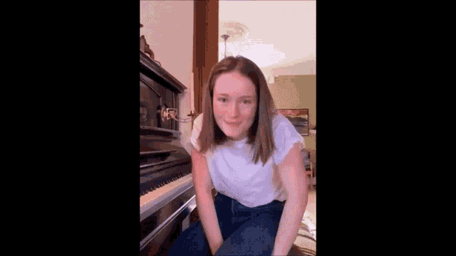a person standing in a living room with a piano in the foreground
