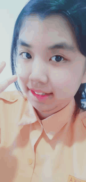 a girl wearing an orange shirt with the word asylum on the sleeve
