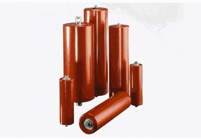 two metal cylinders are sitting on a table with a black background