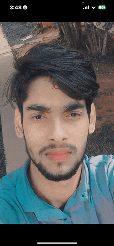 a man with a beard is taking a selfie on his phone with the time of 3:48