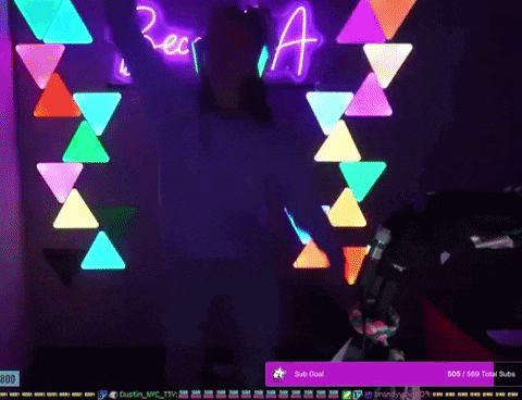 a person is dancing in front of a neon sign that says rec a
