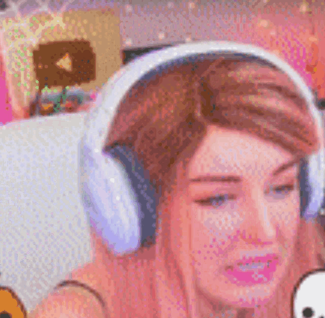 a woman wearing headphones is sitting in a chair .