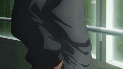 a person in a suit stands in front of a window
