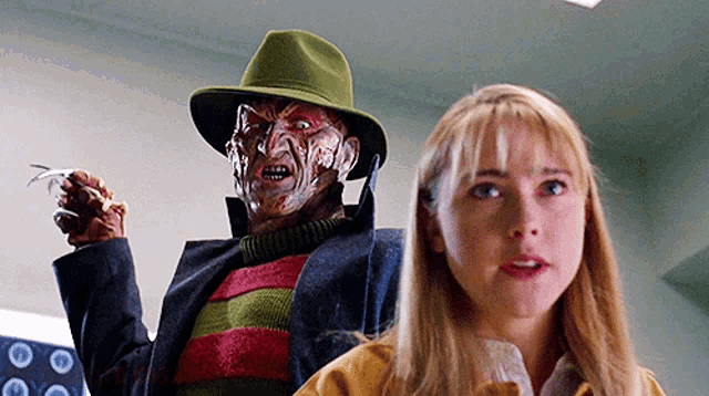 a woman is standing next to a freddy krueger doll