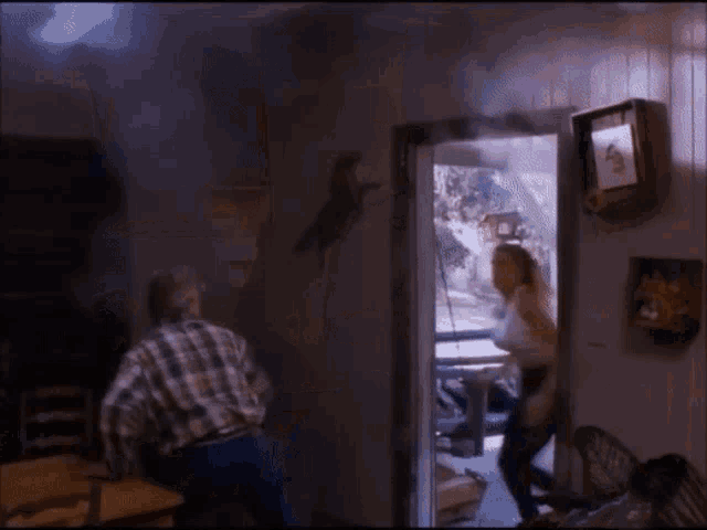 a man and woman are dancing in a room