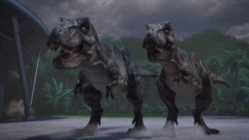 a couple of dinosaurs are standing next to each other