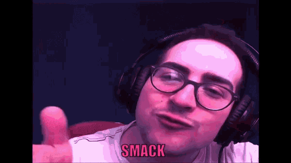 a man wearing headphones and glasses says smack in pink letters