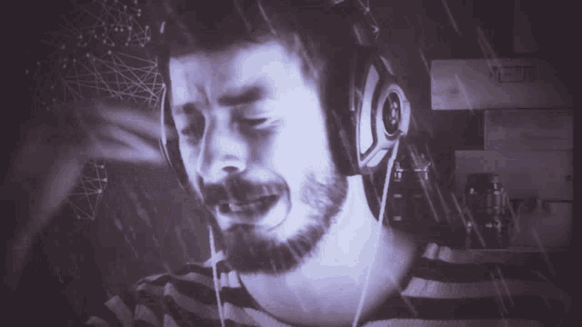 a man with a beard wearing headphones with the letter j on them