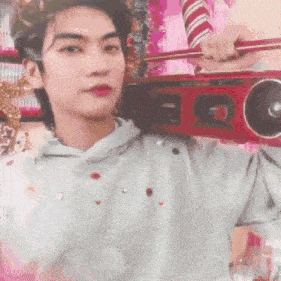 a man is holding a red radio over his shoulder .