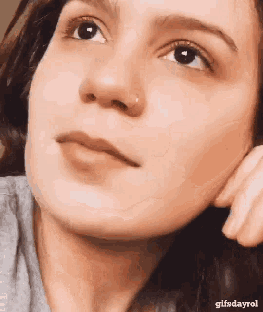 a close up of a woman 's face with a gifsdayrol watermark