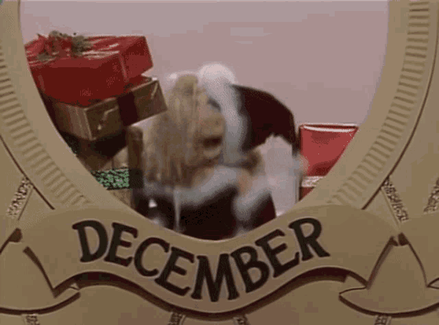 a picture of a pig dressed as santa claus behind a sign that reads december