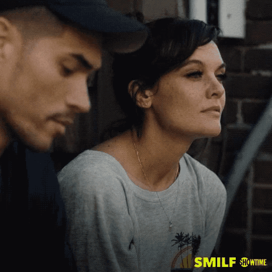 a man and a woman are sitting next to each other on a showtime ad for smilf