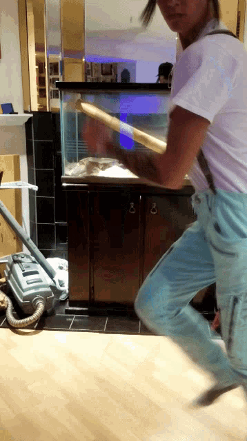 a vacuum cleaner is on the floor in front of a cabinet