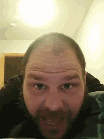 a close up of a man 's face with a beard