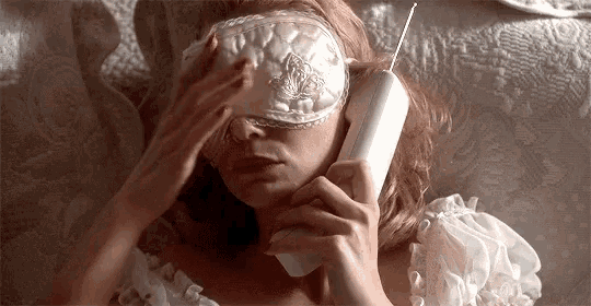 a woman is wearing a sleep mask and talking on a cell phone .