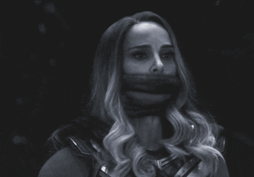 a black and white photo of a woman with her mouth taped shut