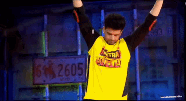 a man is wearing a yellow shirt that says mantra on it